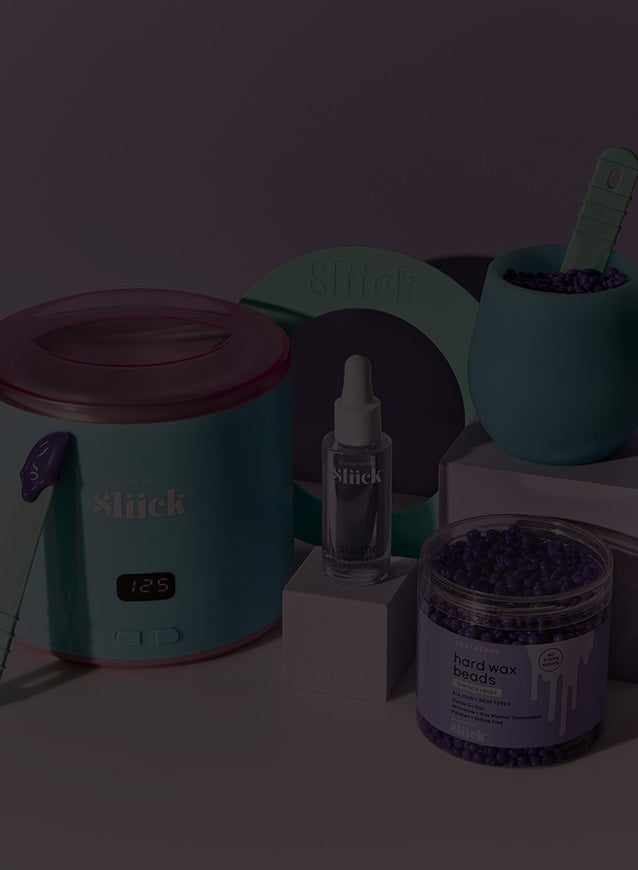 Sliick products including a warmer, serum bottle, and wax beads on a dark background.