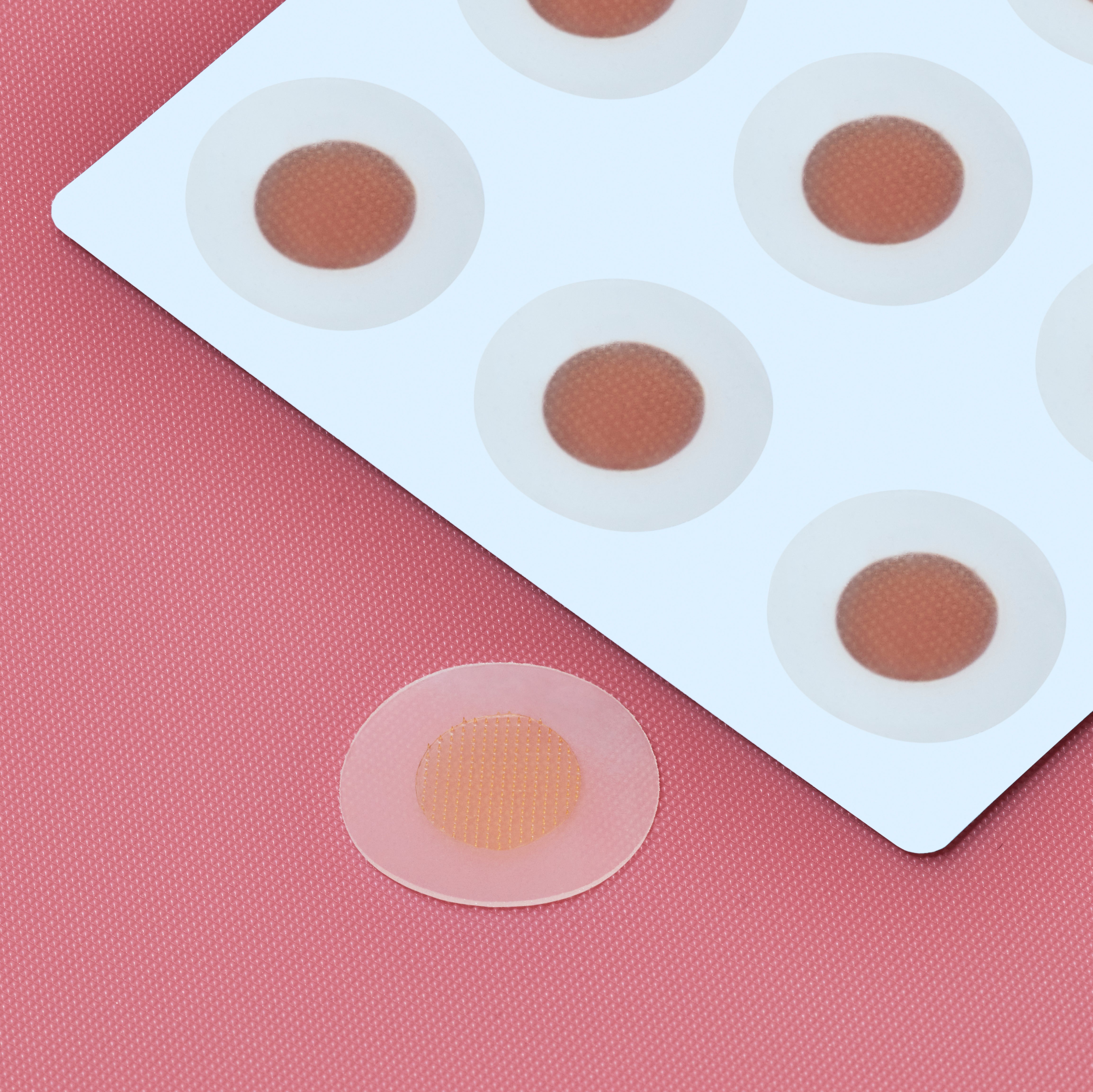 Sliick Ingrown Patches on white card with a pink background