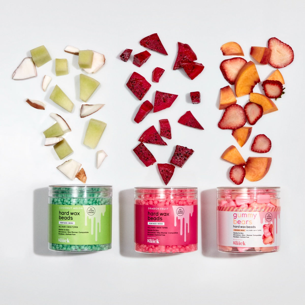 Sliick Hard Wax Beads – Coconut Melon, Dragon Fruit & Strawberry Peach scents, displayed with fresh fruit. Strip-free for face & body.