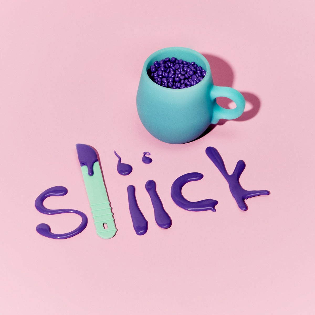 Sliick Branding in Wax – Sliick logo spelled in melted purple wax, mint spatula & silicone melting cup with wax beads on a pastel pink background.